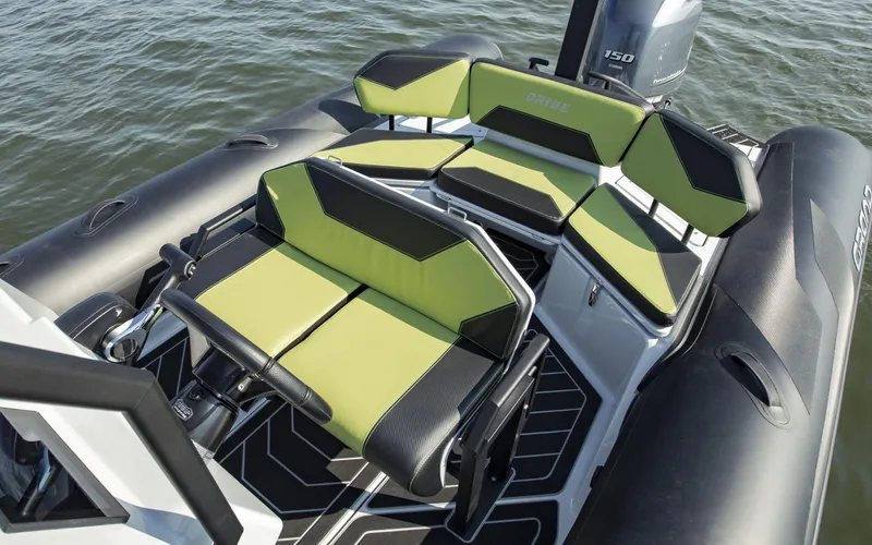 Slide: The Image of 2024 Grand D600 boat with green and black seating on water. - 3