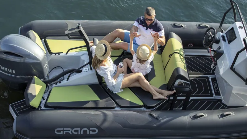 Slide: The Image of Family enjoying a day on a 2024 Grand D600 boat with Yamaha engine. - 4