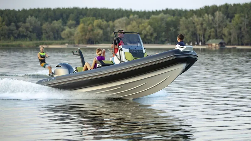 Slide: The Image of 2024 Grand D600 boat towing a wakeboarder on a lake. - 5