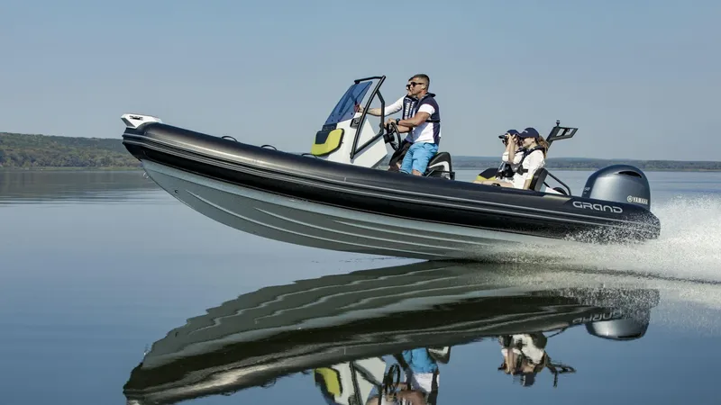Slide: The Image of 2024 Grand D600 boat speeding on calm water with passengers. - 7