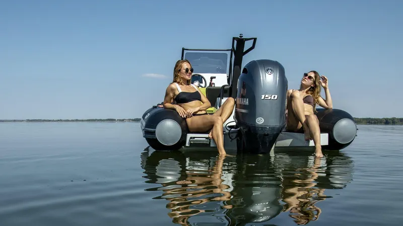 Slide: The Image of Two women relaxing on a 2024 Grand D600 boat in calm waters. - 8
