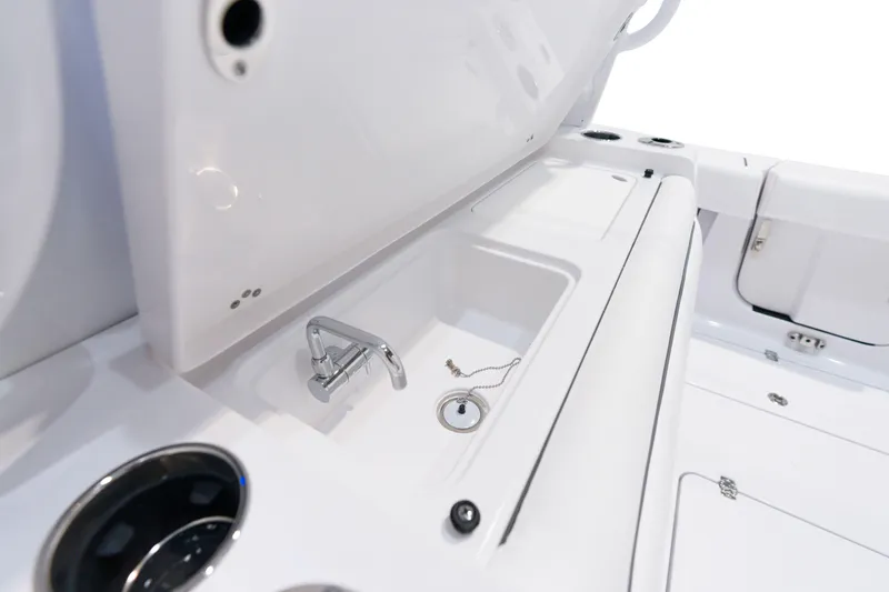 Slide: The Image of 2025 Sportsman Open 352 Center Console boat interior sink and storage area. - 27