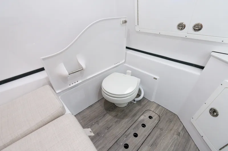 Slide: The Image of 2025 Sportsman Open 352 Center Console boat interior bathroom with toilet and seating. - 31