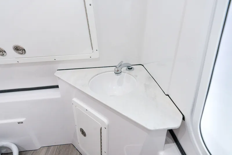 Slide: The Image of Compact sink area in the 2025 Sportsman Open 352 Center Console boat. - 32