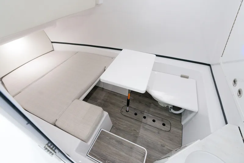 Slide: The Image of 2025 Sportsman Open 352 Center Console cabin interior with seating and table. - 34