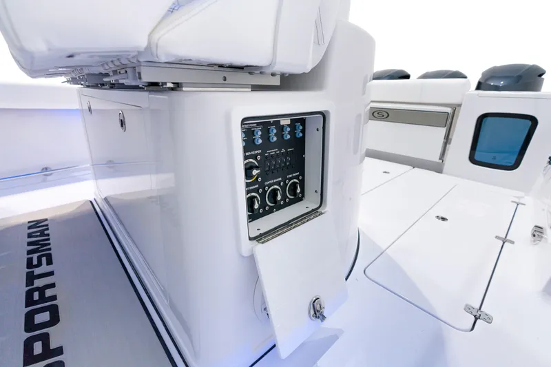 Slide: The Image of 2025 Sportsman Open 352 Center Console boat control panel and storage compartment. - 36