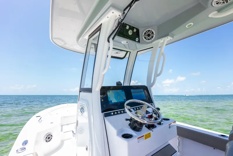 Slide: The Image of 2024 Sportsman Masters 247 Bay Boat console with ocean view. - 10