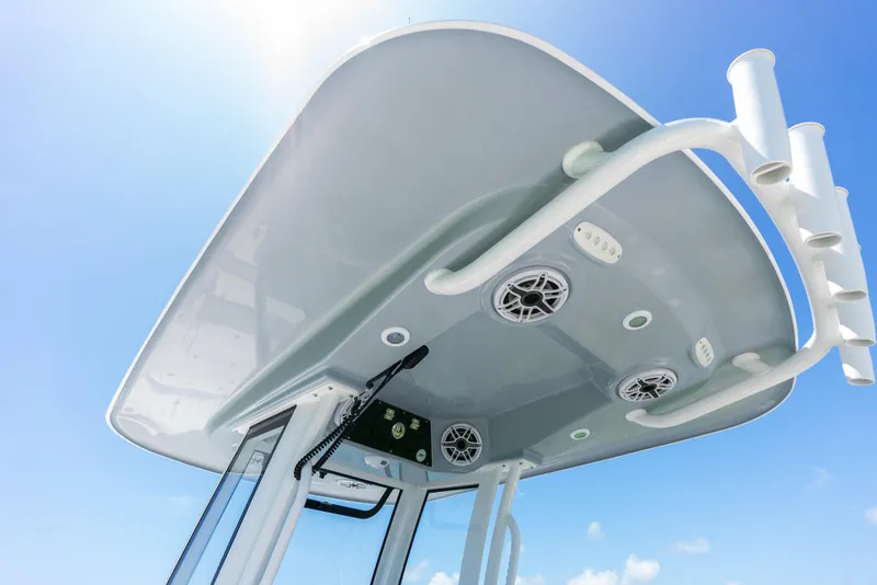 Slide: The Image of 2024 Sportsman Masters 247 Bay Boat T-top with speakers and rod holders. - 25