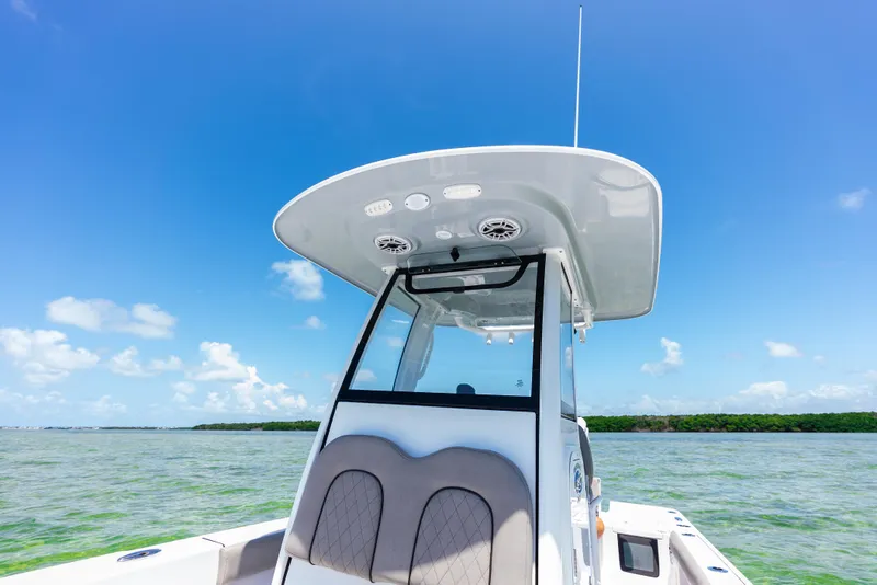 Slide: The Image of 2024 Sportsman Masters 247 Bay Boat on open water under clear blue sky. - 26