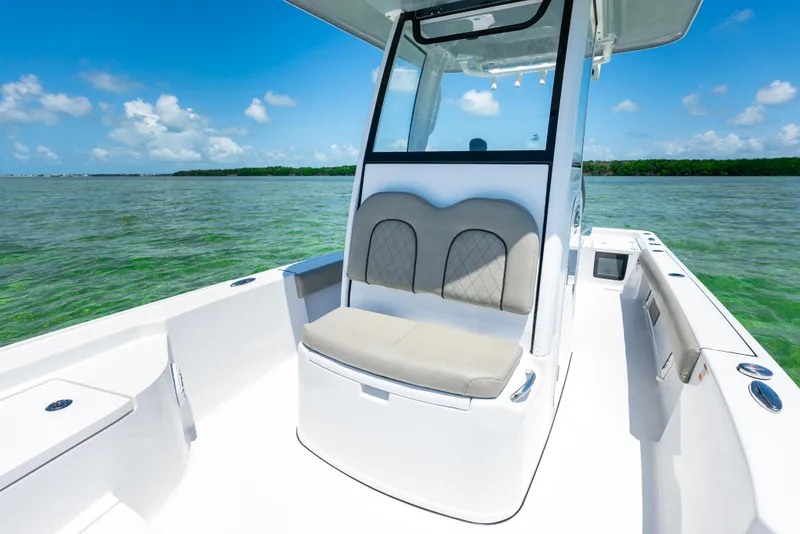 Slide: The Image of 2024 Sportsman Masters 247 Bay Boat interior with cushioned seating. - 5