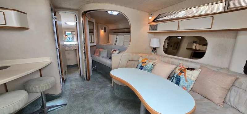 Slide: The Image of Interior of a 1992 Sea Ray 400 Express Cruiser with cozy seating and modern decor. - 1