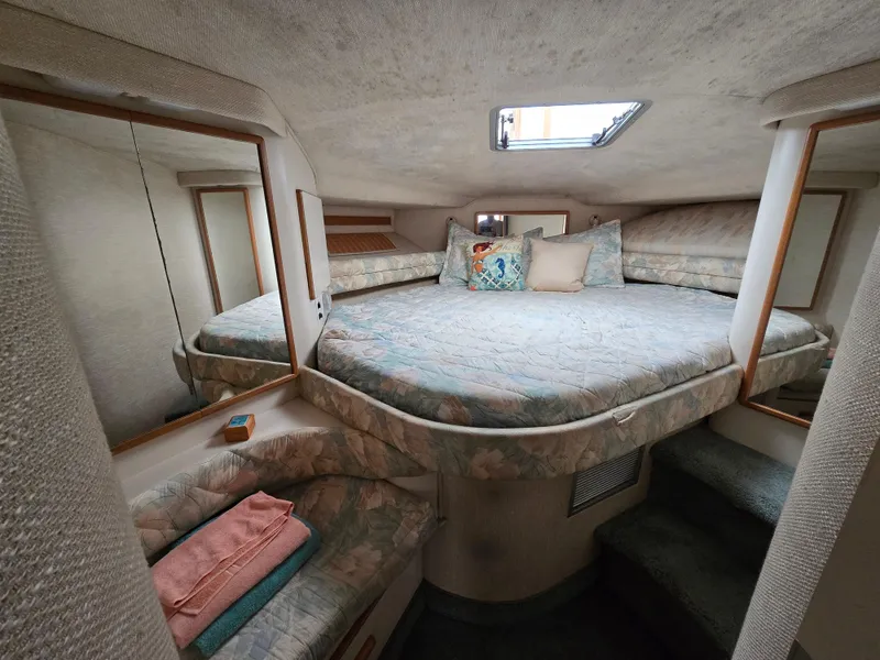Slide: The Image of Interior of 1992 Sea Ray 400 Express Cruiser with cozy bed and mirrors. - 3