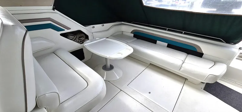 Slide: The Image of Interior of 1992 Sea Ray 400 Express Cruiser with white seating and table. - 5