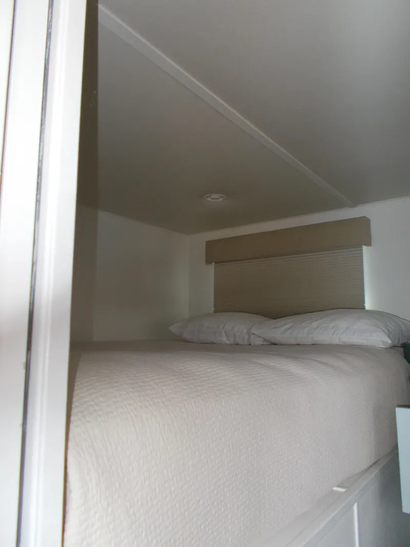 Slide: The Image of Luxurious interior of 1992 Jamestowner Silver Lining houseboat with modern kitchen and cozy seating area. - 11