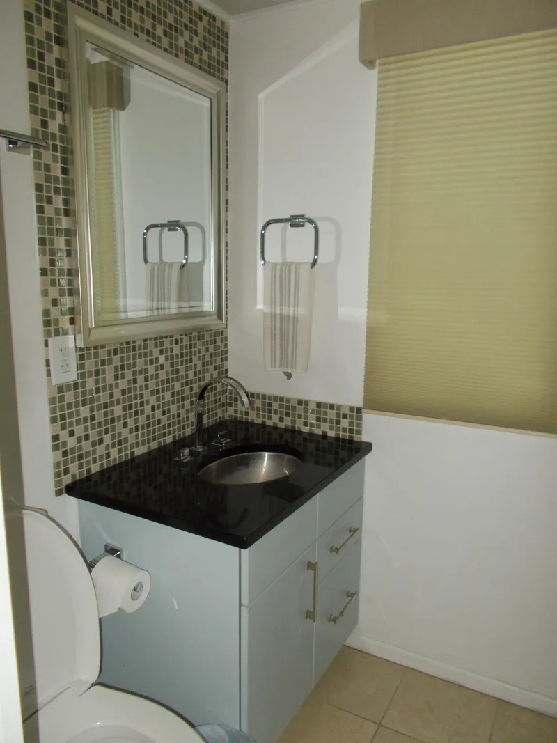 Slide: The Image of Interior of 1992 Jamestowner Silver Lining houseboat with modern kitchen and cozy seating area. - 13