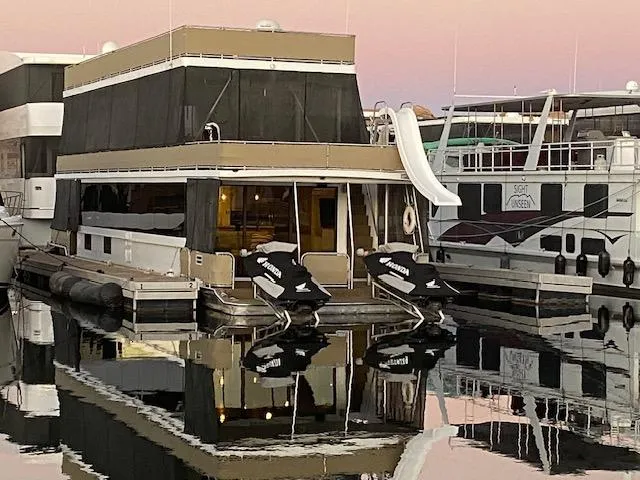 Slide: The Image of Compact kitchen area in 1992 Jamestowner Silver Lining houseboat with stove and water dispenser. - 2