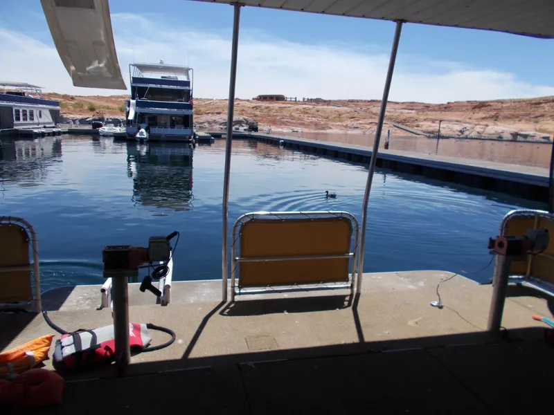 Slide: The Image of Narrow hallway with white cabinets and decor in a 1992 Jamestowner Silver Lining houseboat. - 7