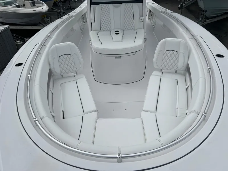 Slide: The Image of 2024 Sportsman Open 352 boat interior with white cushioned seating. - 11