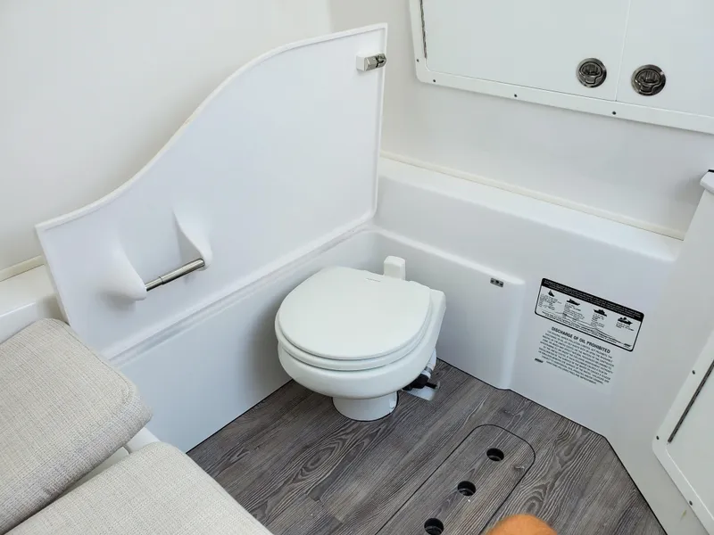 Slide: The Image of 2024 Sportsman Open 352 boat bathroom with modern fixtures and wood flooring. - 18