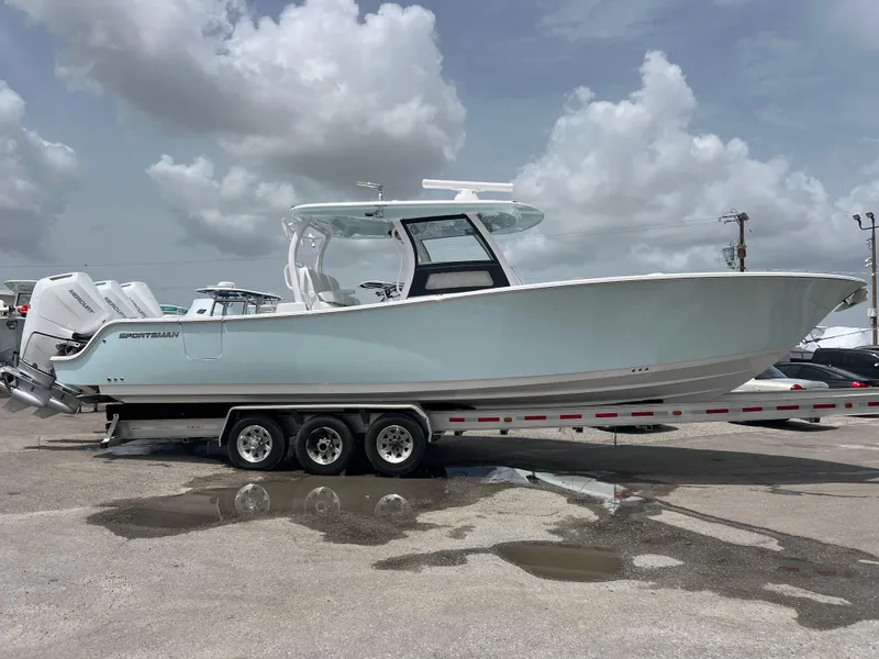 Slide: The Image of 2024 Sportsman Open 352 boat on a trailer under cloudy skies. - 2
