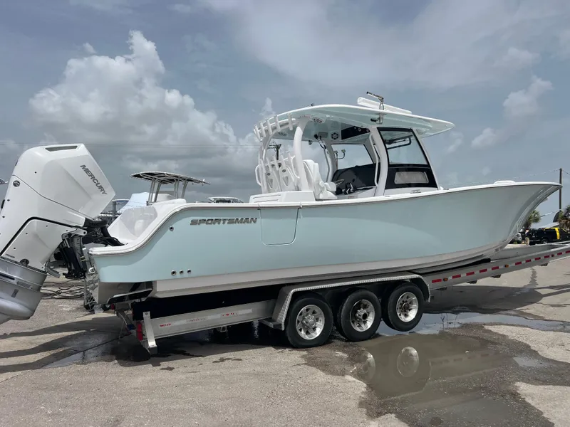 Slide: The Image of 2024 Sportsman Open 352 boat on a trailer with twin outboard engines. - 3