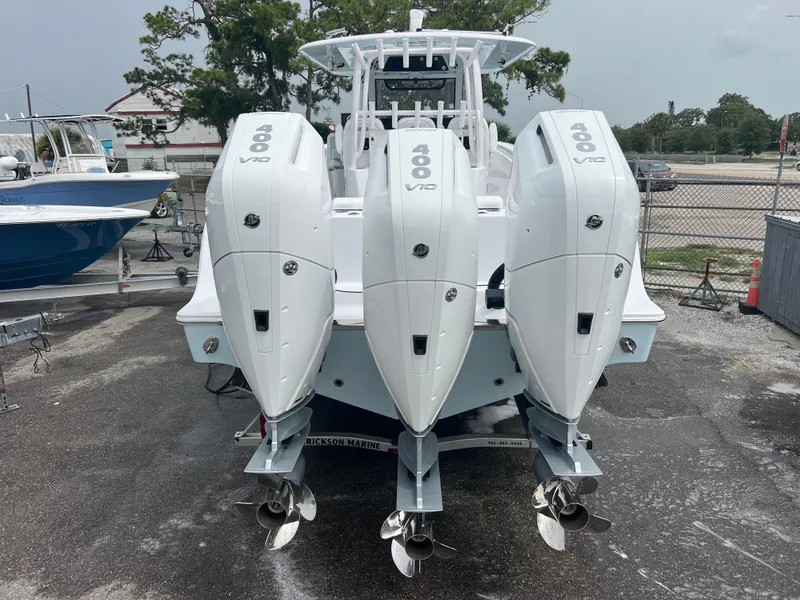Slide: The Image of 2024 Sportsman Open 352 boat with triple outboard engines, rear view. - 4
