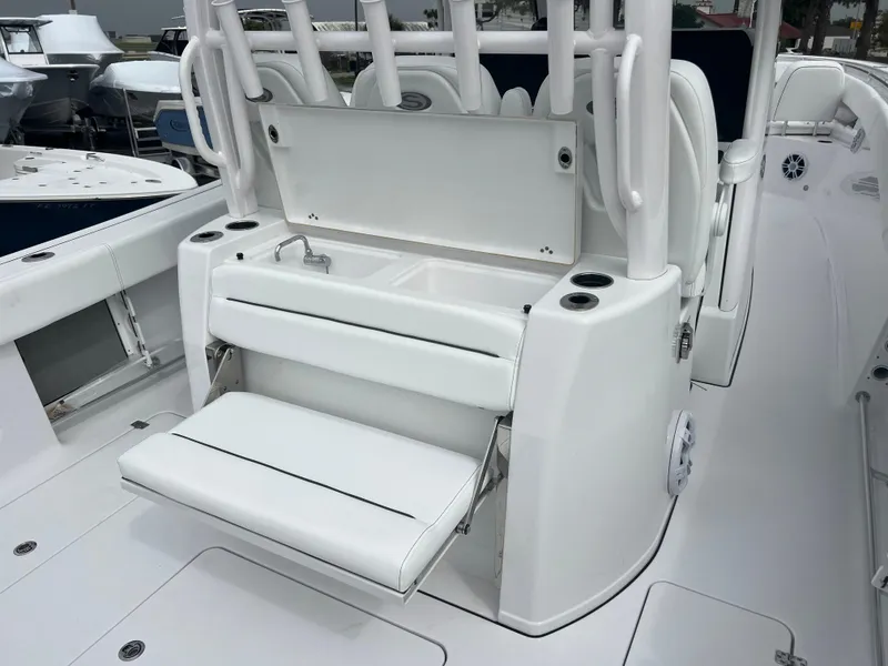 Slide: The Image of 2024 Sportsman Open 352 boat interior with fold-out seating and storage. - 7