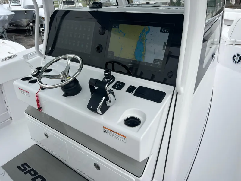 Slide: The Image of 2024 Sportsman Open 352 boat dashboard with navigation screen and controls. - 8