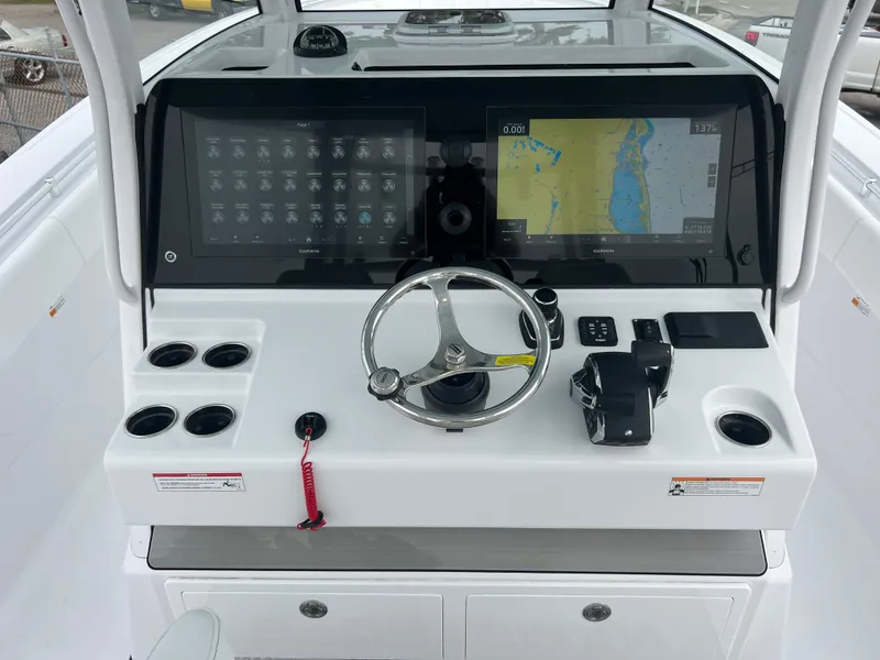 Slide: The Image of 2024 Sportsman Open 352 boat dashboard with navigation screens and steering wheel. - 9