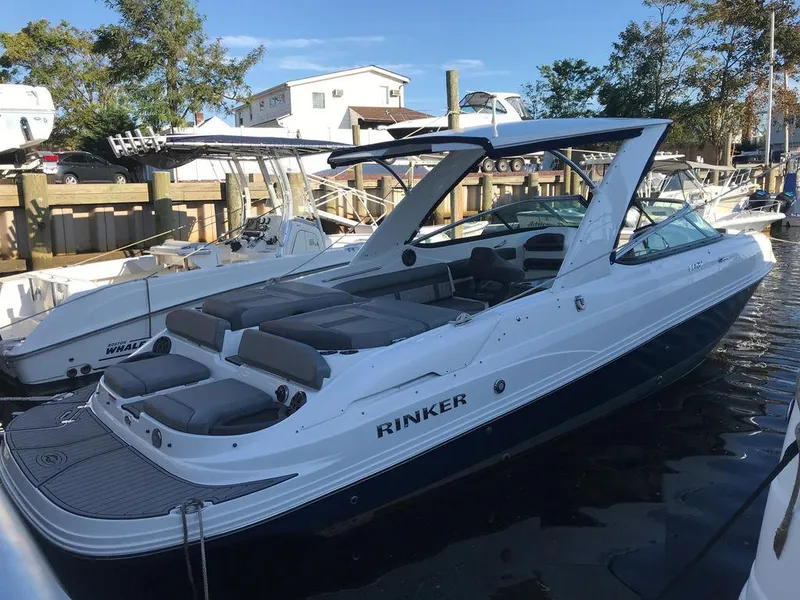 The Image of 2020 Rinker 29QX BR boat docked at a marina. - 0