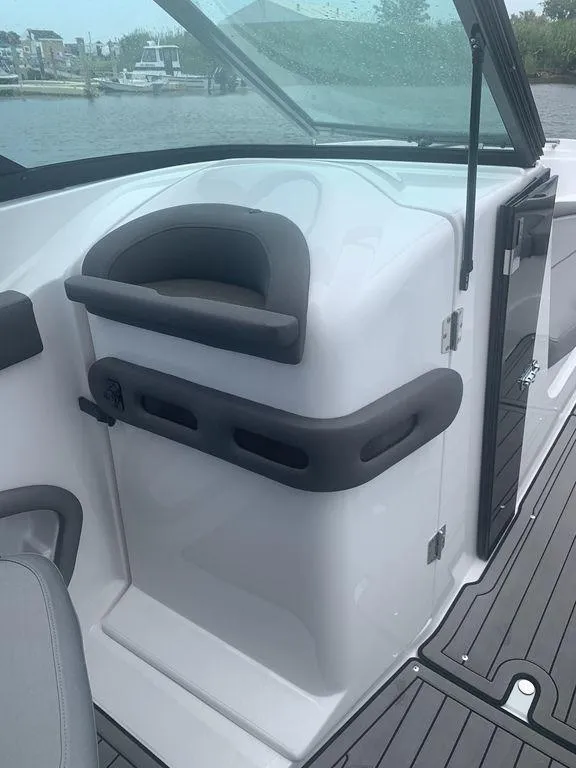 Slide: The Image of 2020 Rinker 29QX BR boat interior with helm station and windshield. - 12