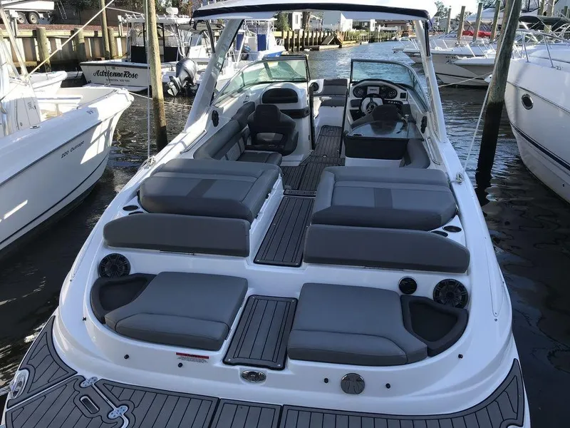 Slide: The Image of 2020 Rinker 29QX BR boat with spacious seating and modern design docked at marina. - 14