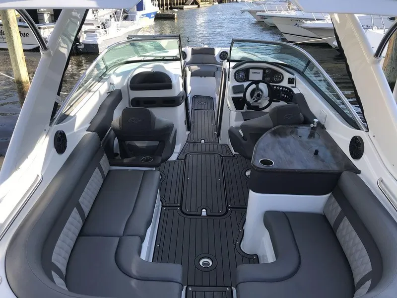 Slide: The Image of 2020 Rinker 29QX BR boat interior with luxurious seating and modern dashboard. - 18