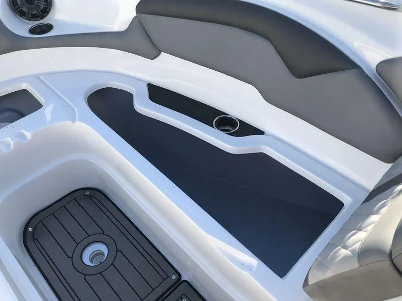 Slide: The Image of 2020 Rinker 29QX BR boat interior with sleek seating and storage compartments. - 23