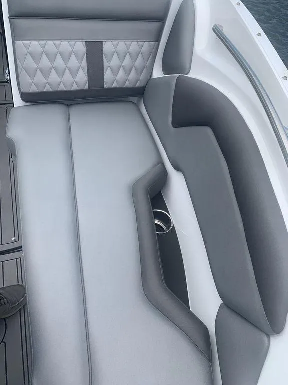 Slide: The Image of 2020 Rinker 29QX BR boat interior with gray and white cushioned seating. - 27