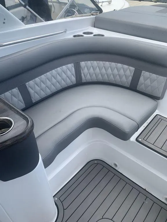 Slide: The Image of 2020 Rinker 29QX BR boat interior with gray cushioned seating. - 5