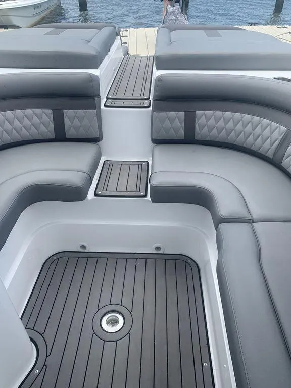 Slide: The Image of 2020 Rinker 29QX BR boat interior with gray seating and deck. - 6