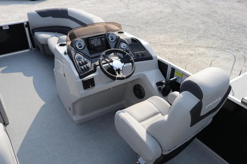 Slide: The Image of 2023 Sylvan L5 DLZ Bar boat interior with steering console and seating area. - 14