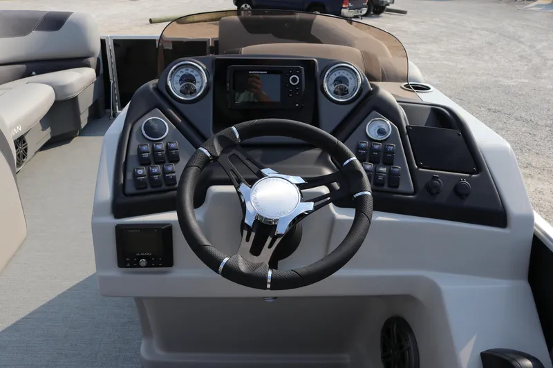 Slide: The Image of 2023 Sylvan L5 DLZ Bar boat dashboard with steering wheel and control panel. - 15