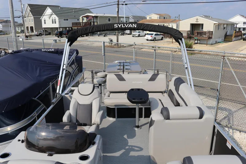 Slide: The Image of 2023 Sylvan L5 DLZ Bar pontoon boat with spacious seating and modern design. - 16