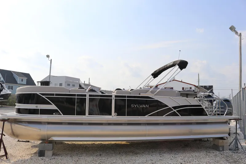 Slide: The Image of 2023 Sylvan L5 DLZ Bar pontoon boat on display outdoors. - 23