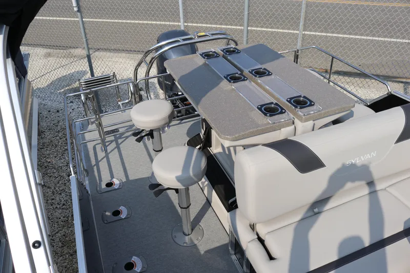 Slide: The Image of 2023 Sylvan L5 DLZ Bar pontoon boat with bar seating and cup holders. - 7