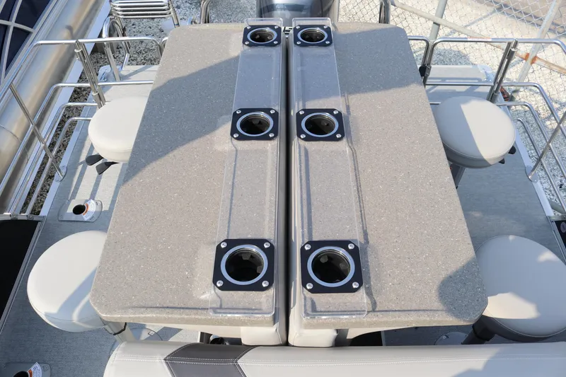 Slide: The Image of 2023 Sylvan L5 DLZ Bar with seating and table setup on a pontoon boat. - 9