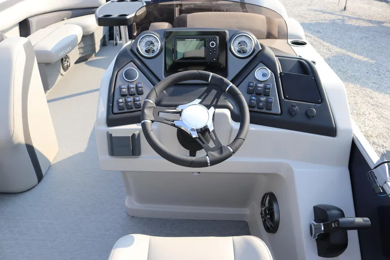 Slide: The Image of 2023 Sylvan L3 Party Fish boat dashboard with steering wheel and control panel. - 11