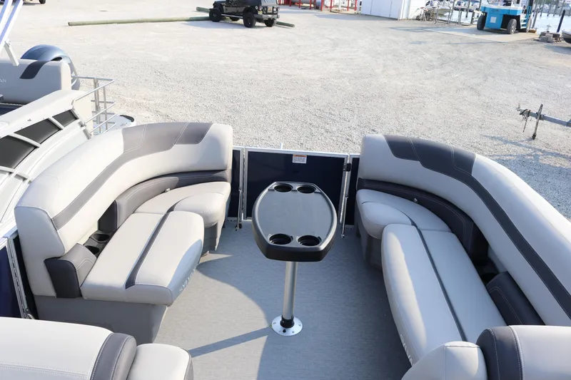 Slide: The Image of 2023 Sylvan L3 Party Fish pontoon boat interior with gray seating and central table. - 12
