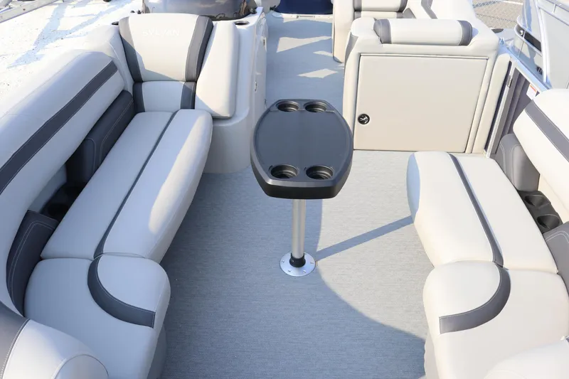 Slide: The Image of 2023 Sylvan L3 Party Fish boat interior with gray seating and central table. - 4
