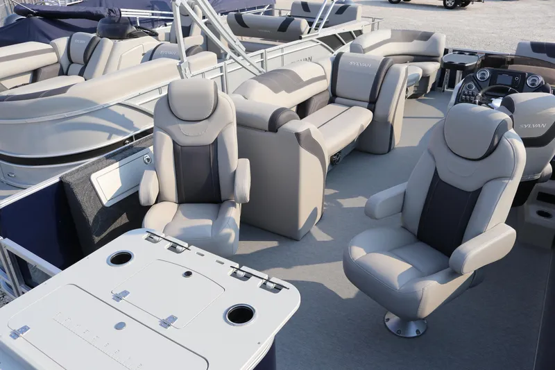 Slide: The Image of 2023 Sylvan L3 Party Fish boat interior with plush seating and table setup. - 9