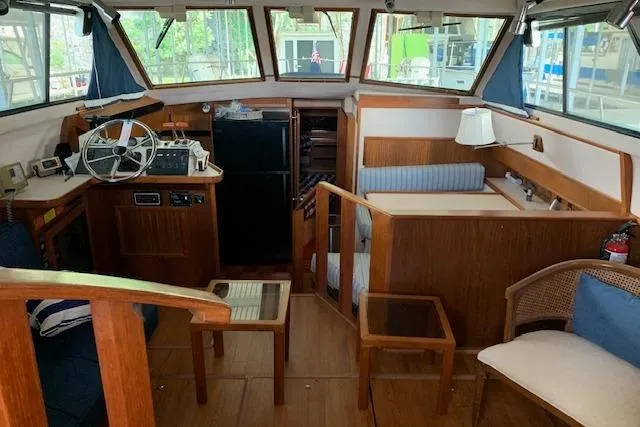 Slide: The Image of 1987 Sea Ray 410 Aft Cabin interior with wood paneling and helm station. - 13