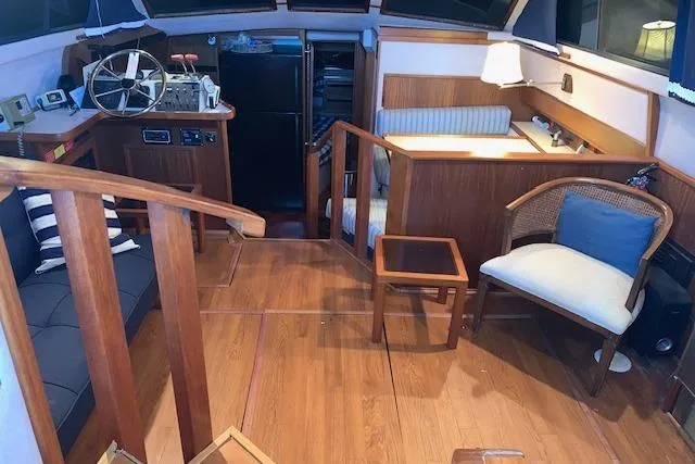 Slide: The Image of Interior of 1987 Sea Ray 410 Aft Cabin with wooden furnishings and helm station. - 14