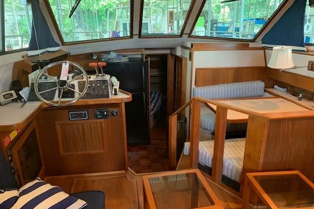 Slide: The Image of 1987 Sea Ray 410 Aft Cabin interior with helm, seating, and wood accents. - 15